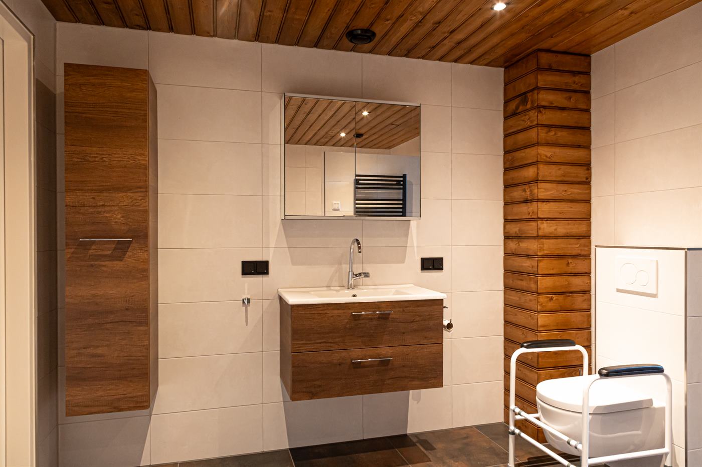 Badkamer met houten wandbekleding en wastafelmeubel